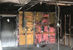 Fire-damaged Florida condominium interior with charred walls