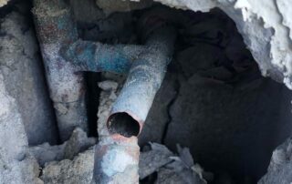 Corroded broken water pipe exposed inside an opened condo wall that caused mold damage in West Palm Beach